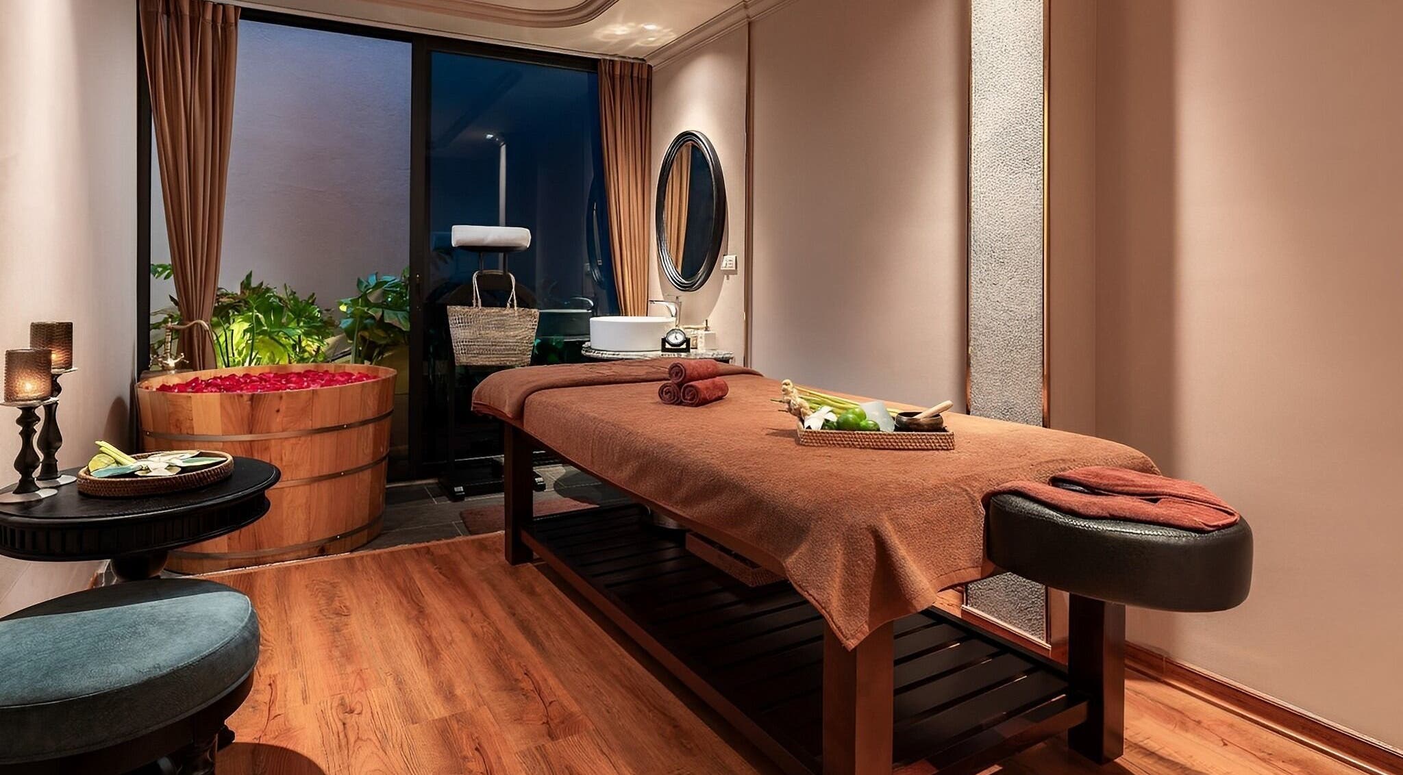 Luxurious treatment room at Serene Signature Spa, Hà Nội, VN, featuring massage table and rose petal tub.