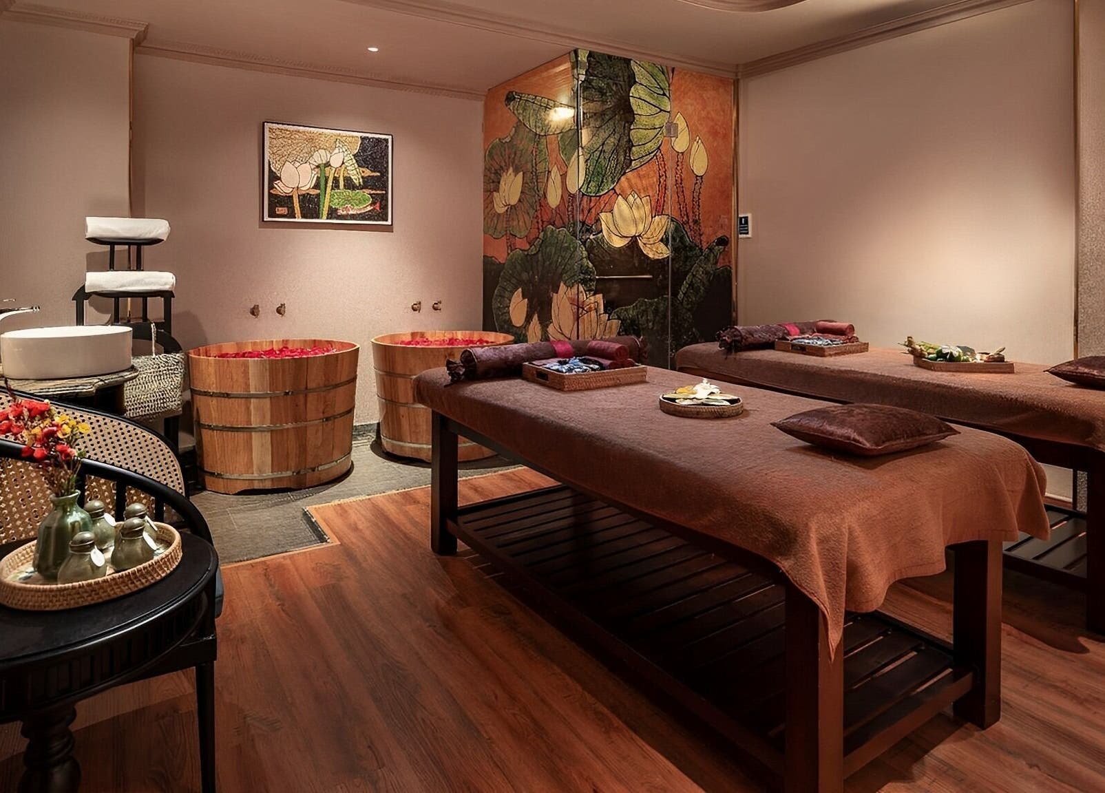 Relaxing treatment room at Serene Signature Spa, Hà Nội, Hà Nội, VN, featuring massage tables and wooden tubs.