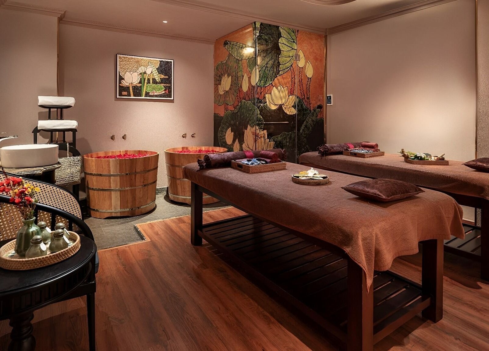 Relaxing treatment room at Serene Signature Spa, Hà Nội, Hà Nội, VN, featuring massage tables and wooden tubs.
