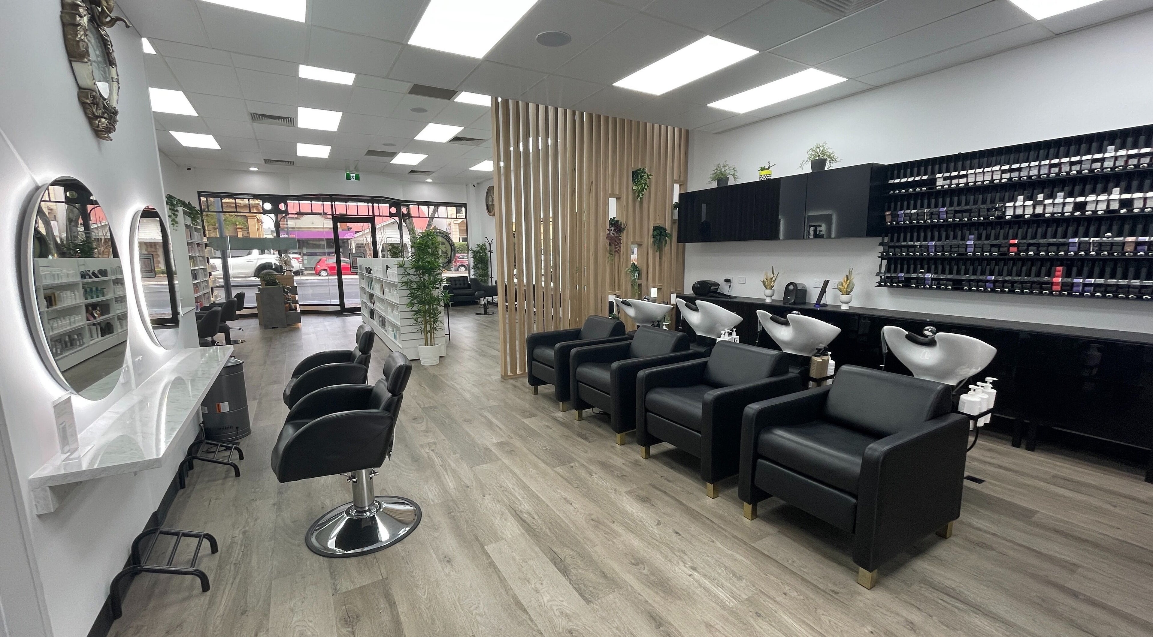 Chic interior of Echo Hair and Beauty in Norwood, South Australia, AU featuring styling chairs and wash stations.