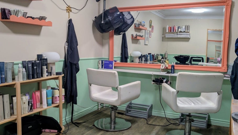 Stylish salon interior at Awesome Hair Is, Eagleby, Queensland, AU, featuring modern chairs and product display.