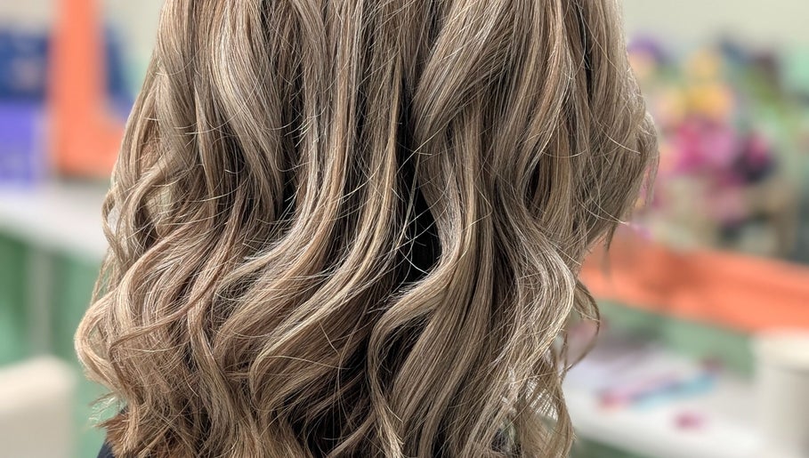 Stylishly curled blonde hair at Awesome Hair Is, Eagleby, Queensland, AU.