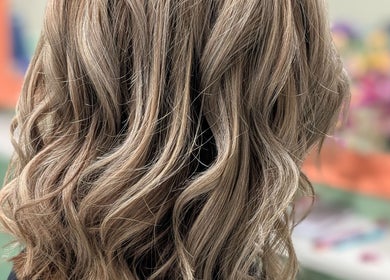 Stylishly curled blonde hair at Awesome Hair Is, Eagleby, Queensland, AU.