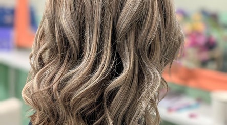 Stylishly curled blonde hair at Awesome Hair Is, Eagleby, Queensland, AU.