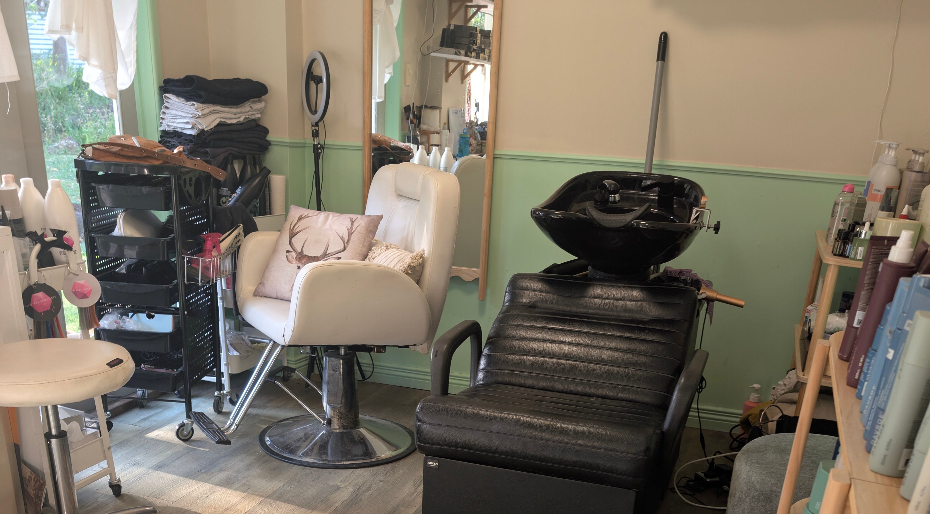 Cozy salon area at Awesome Hair Is, Eagleby, Queensland, AU, with modern hairdressing chairs and products.