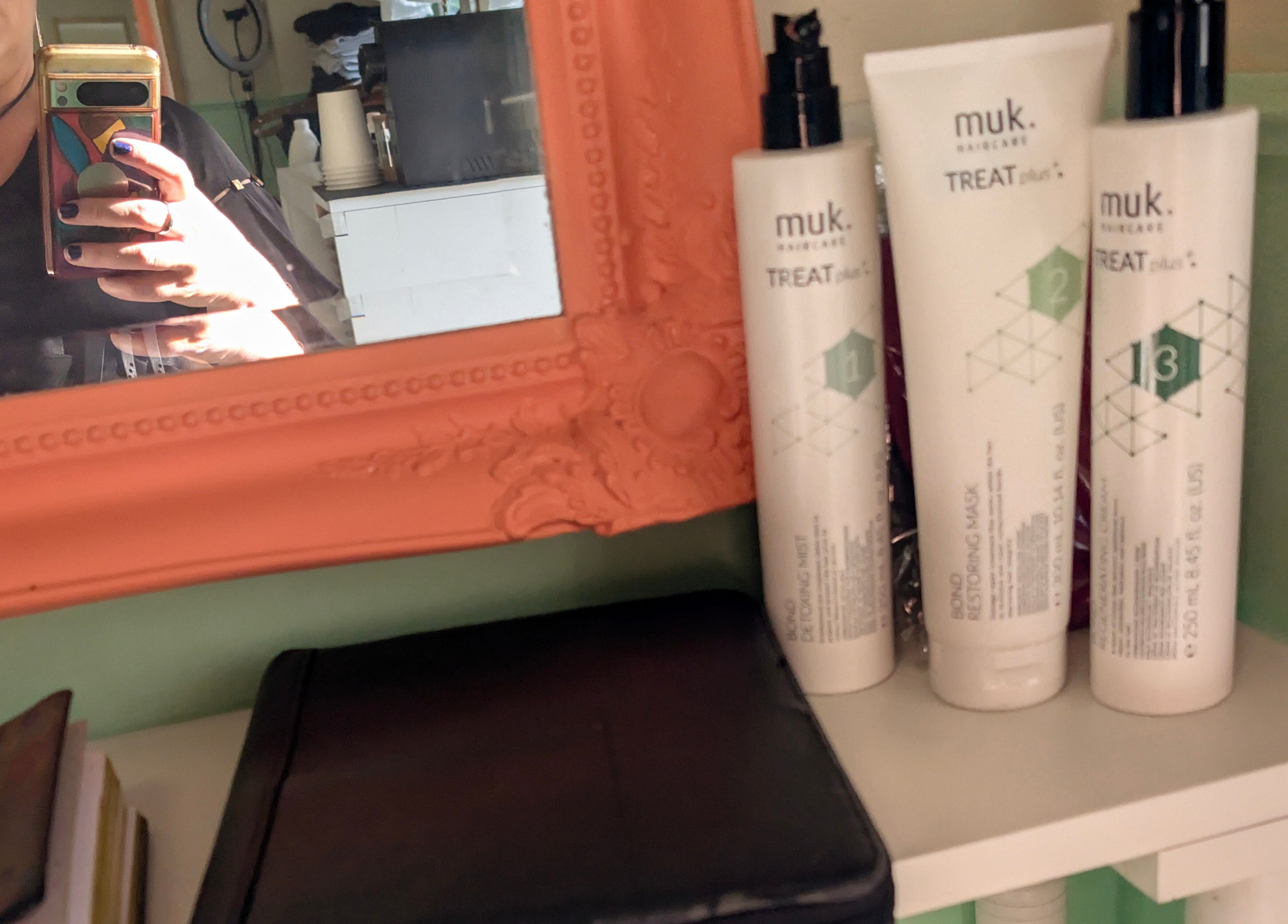 Haircare products and stylist's reflection at Awesome Hair Is in Eagleby, Queensland, AU.