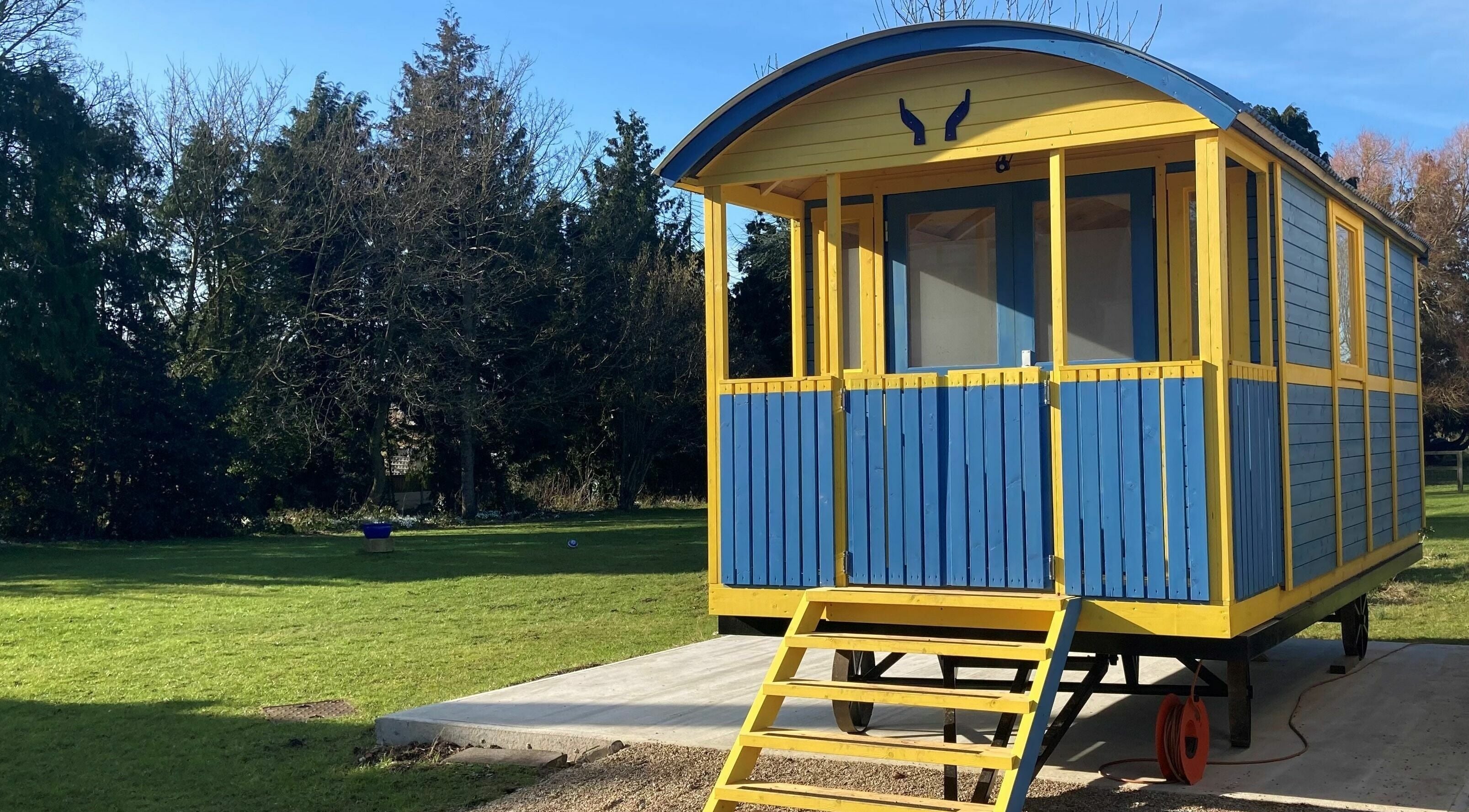 Charming yellow and blue cabin at Emma Cliffe - Holistic and Oncology Massage Therapist in Mulbarton, England, GB.