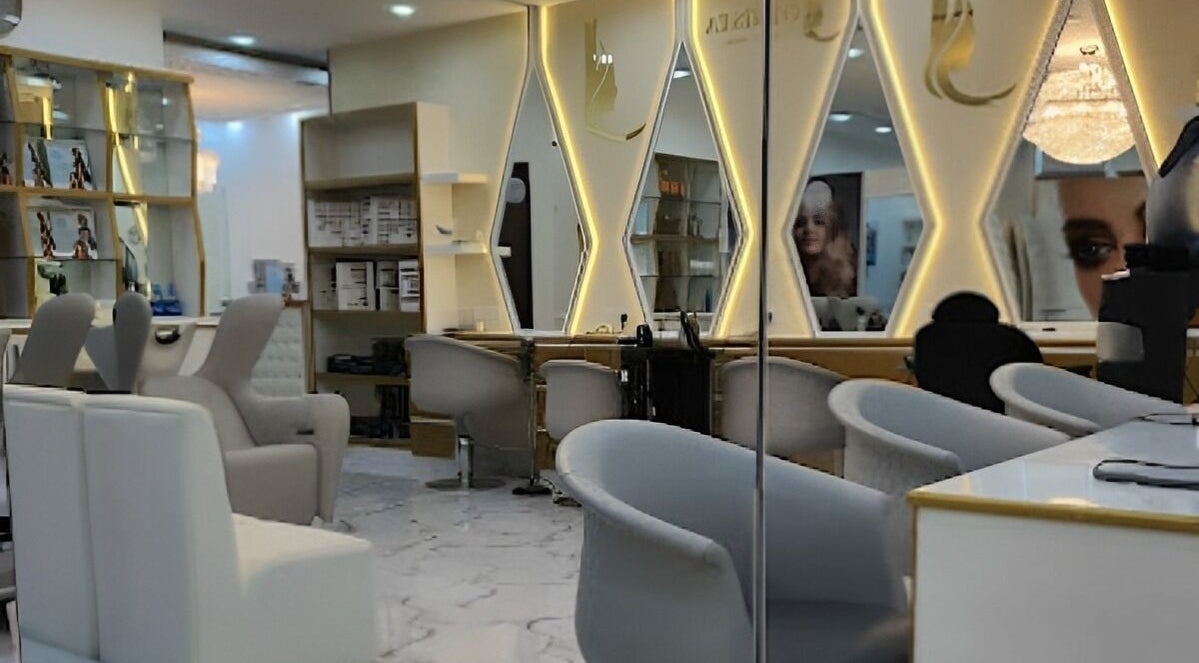 Interior of Rebo Beauty Salon, Dubai, AE, featuring elegant mirrored walls and modern salon chairs.