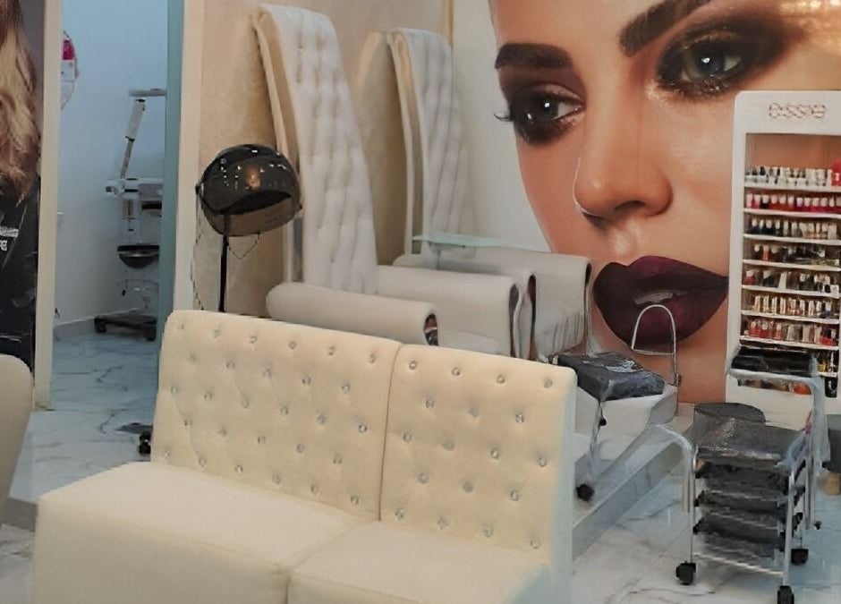 Interior of Rebo Beauty Salon in Dubai, AE showcasing chic seating, nail products, and stylish decor.