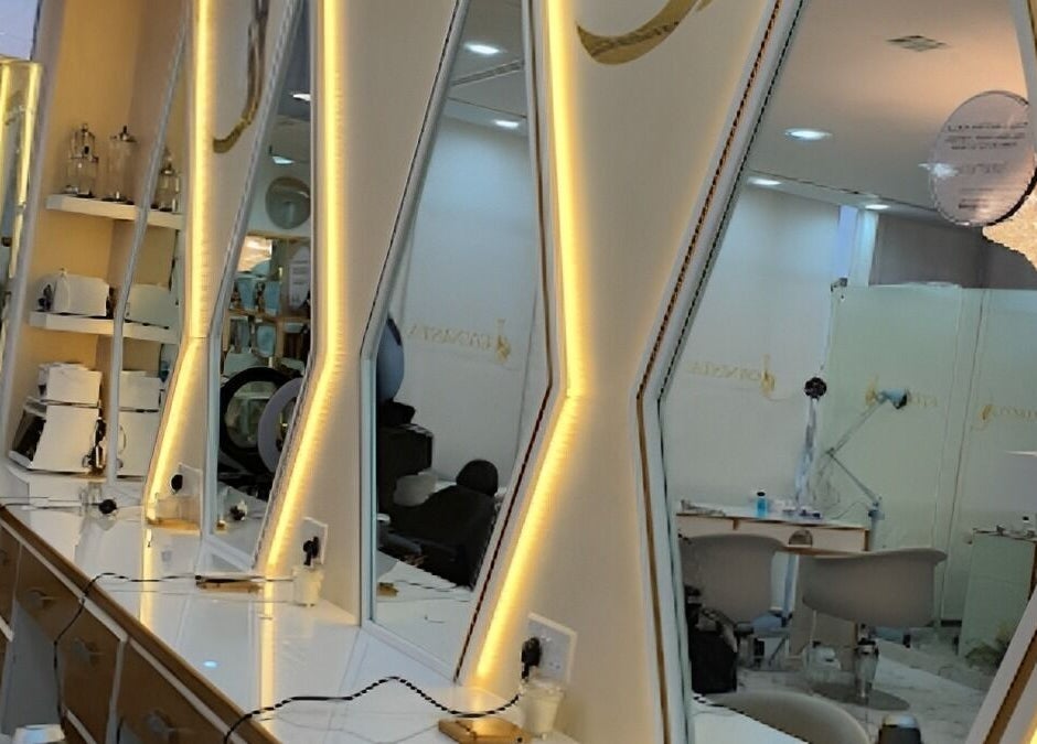 Elegant beauty stations with illuminated mirrors at Rebo Beauty Salon, Dubai, AE, showcasing luxury ambiance.