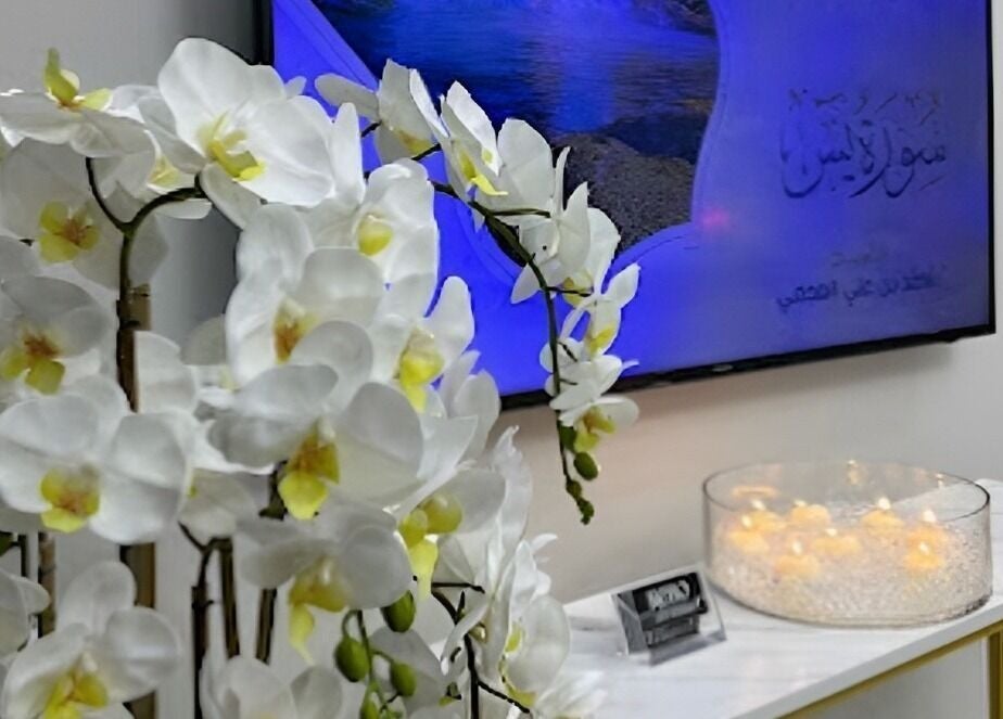 Elegant white orchids at Rebo Beauty Salon entryway, Dubai, AE, enhancing tranquility and luxury.