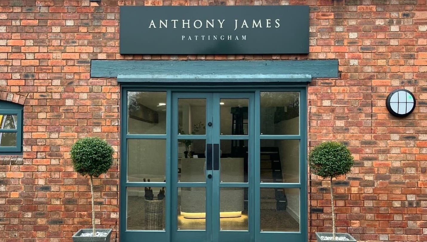 Elegant entrance of Anthony James, Pattingham, GB with brick walls and green door.