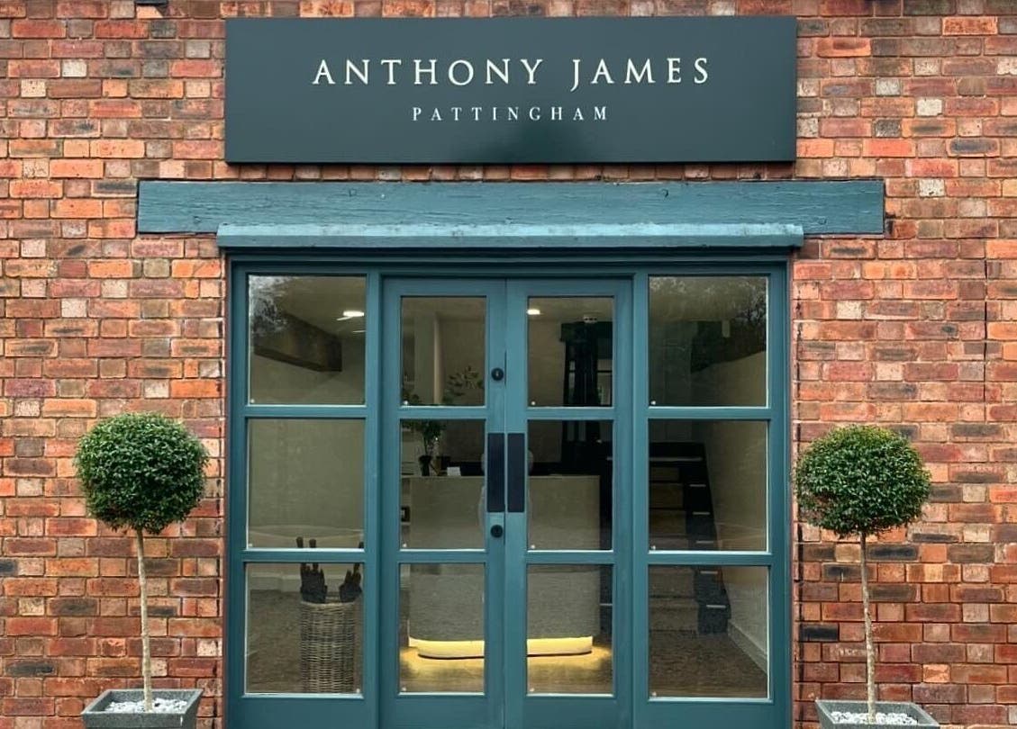 Elegant entrance of Anthony James, Pattingham, GB with brick walls and green door.