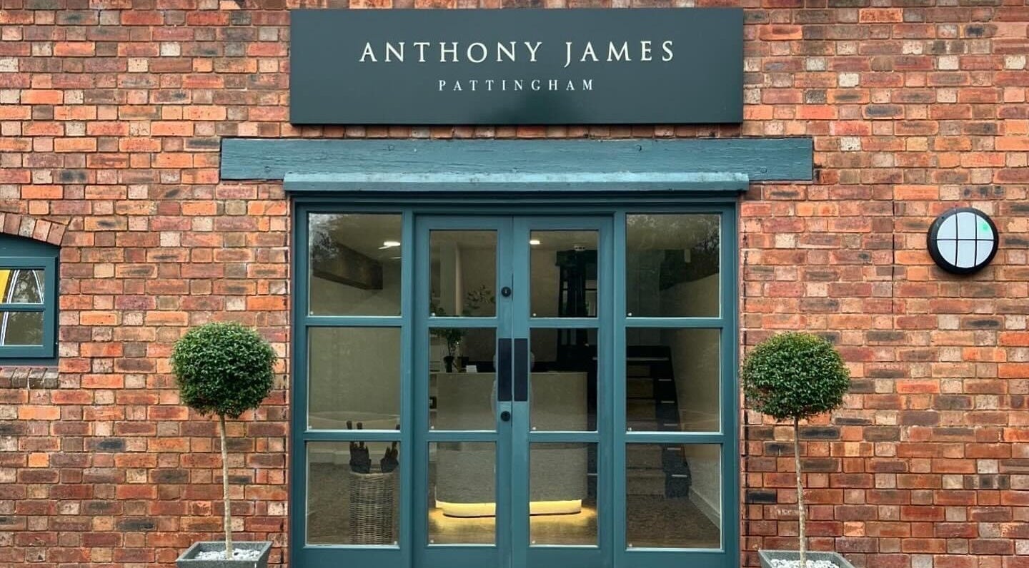 Elegant entrance of Anthony James, Pattingham, GB with brick walls and green door.