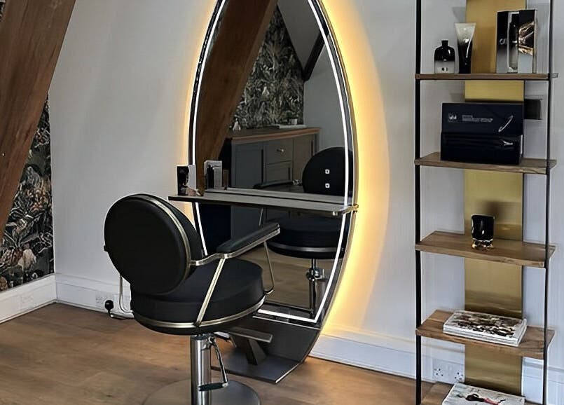 Modern salon chair and illuminated mirror at Anthony James, Pattingham, GB showcasing stylish design.
