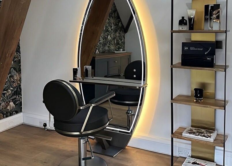 Modern salon chair and illuminated mirror at Anthony James, Pattingham, GB showcasing stylish design.