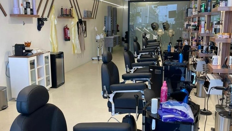 Elegant interior of Trendy Cut | Al Qirawan salon in Riyadh, Riyadh Province, SA featuring modern chairs and styling stations.