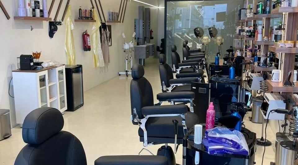 Elegant interior of Trendy Cut | Al Qirawan salon in Riyadh, Riyadh Province, SA featuring modern chairs and styling stations.