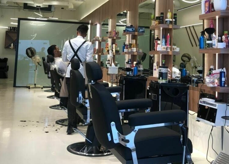 Modern interior of Trendy Cut | Al Qirawan salon in Riyadh, Riyadh Province, SA with barber chairs and mirrors.