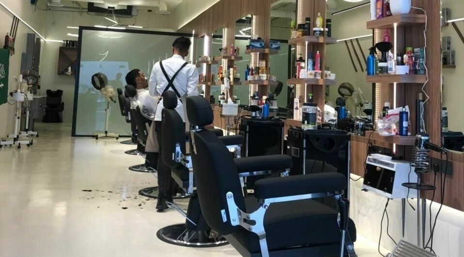 Modern interior of Trendy Cut | Al Qirawan salon in Riyadh, Riyadh Province, SA with barber chairs and mirrors.