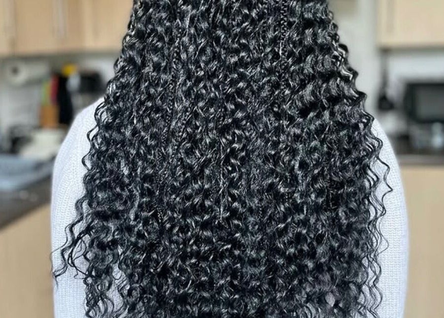 Intricate braids with elegant curls at Jay's Braid Studio in Bristol, England, GB.