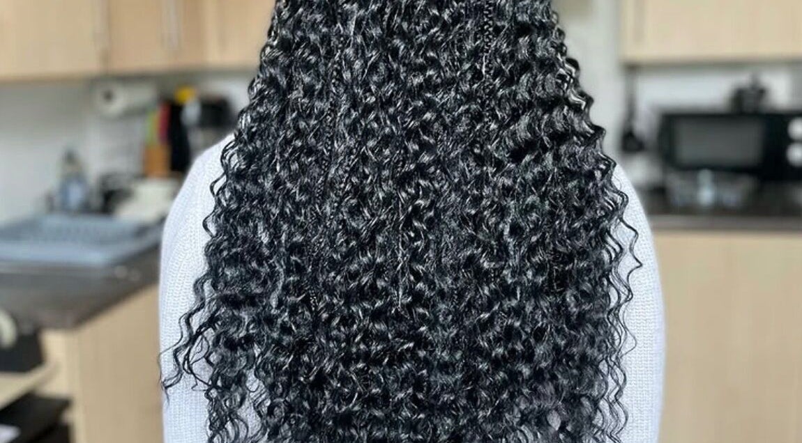 Intricate braids with elegant curls at Jay's Braid Studio in Bristol, England, GB.