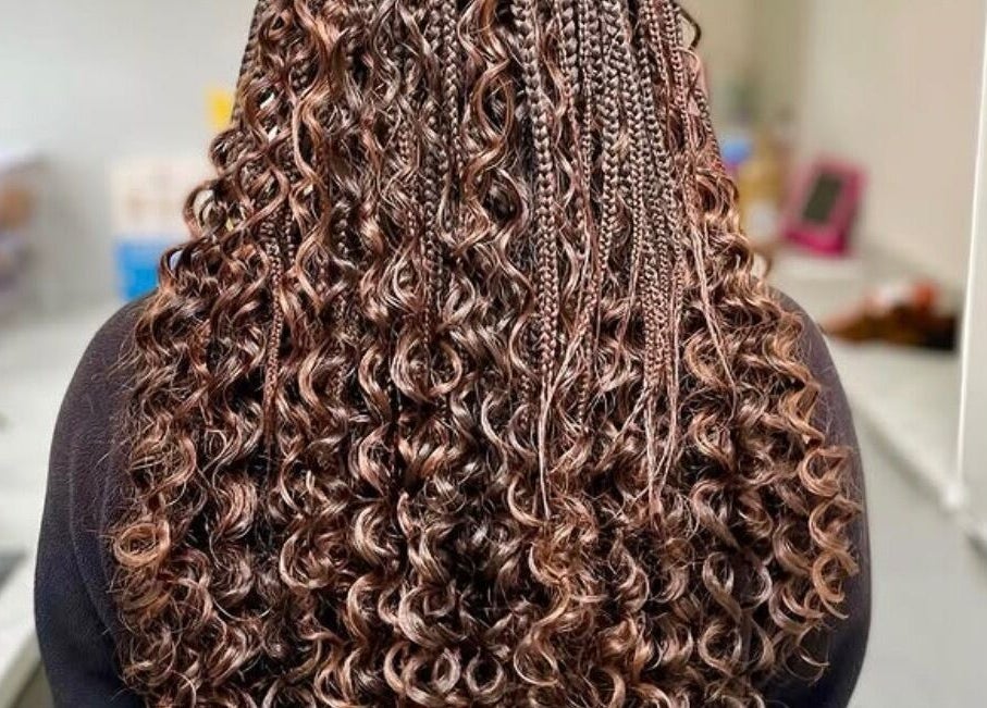 Intricate curly braids hairstyle at Jay's Braid Studio, Bristol, England, GB, showcasing expert craftsmanship.