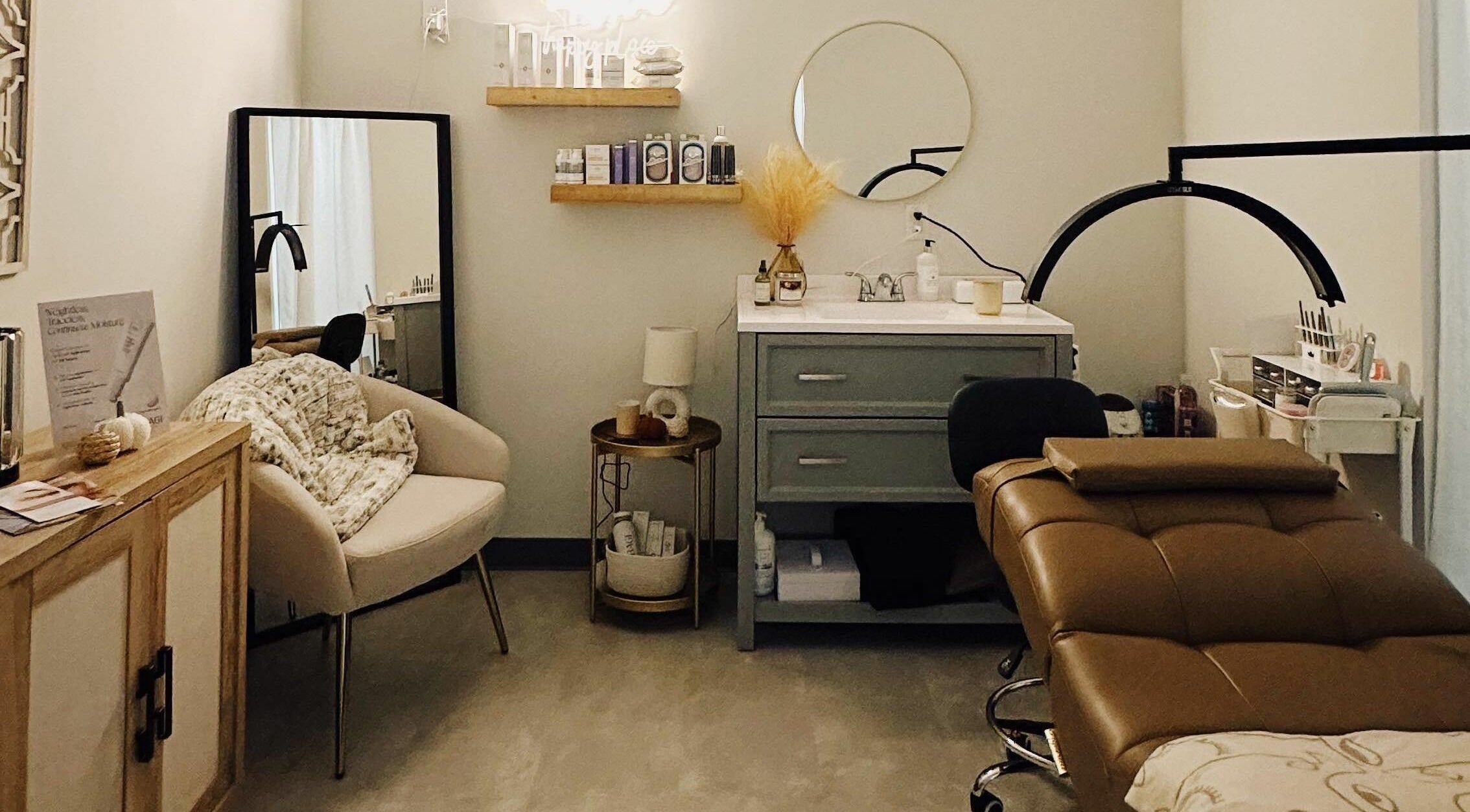 Effortless Beauty Bar LLC's elegant spa room in Buford, Georgia, US features a cozy chair and massage table.