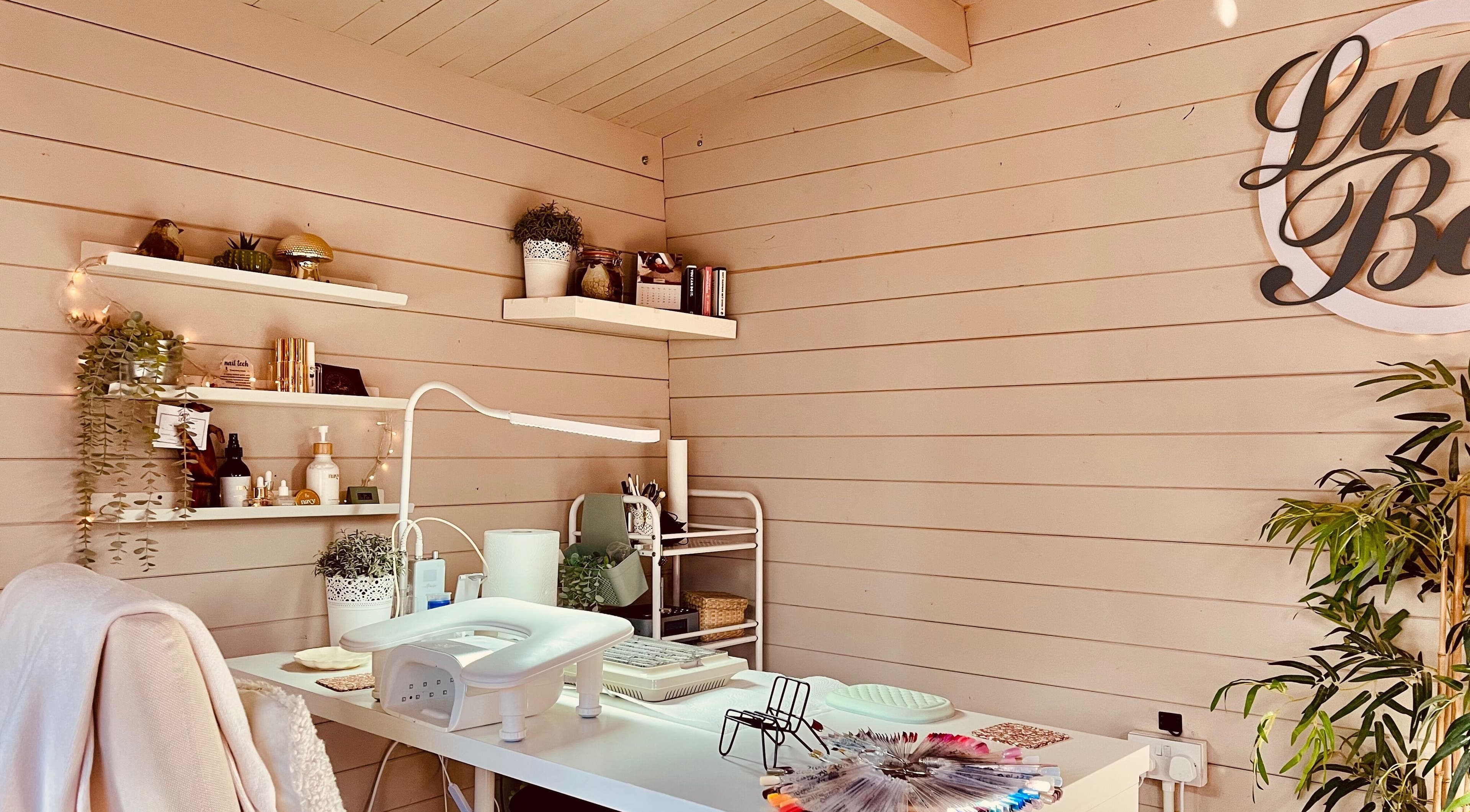 Calming nail studio at Lucy Boo in Kinross, Scotland, GB, featuring tidy shelves and cozy decor.
