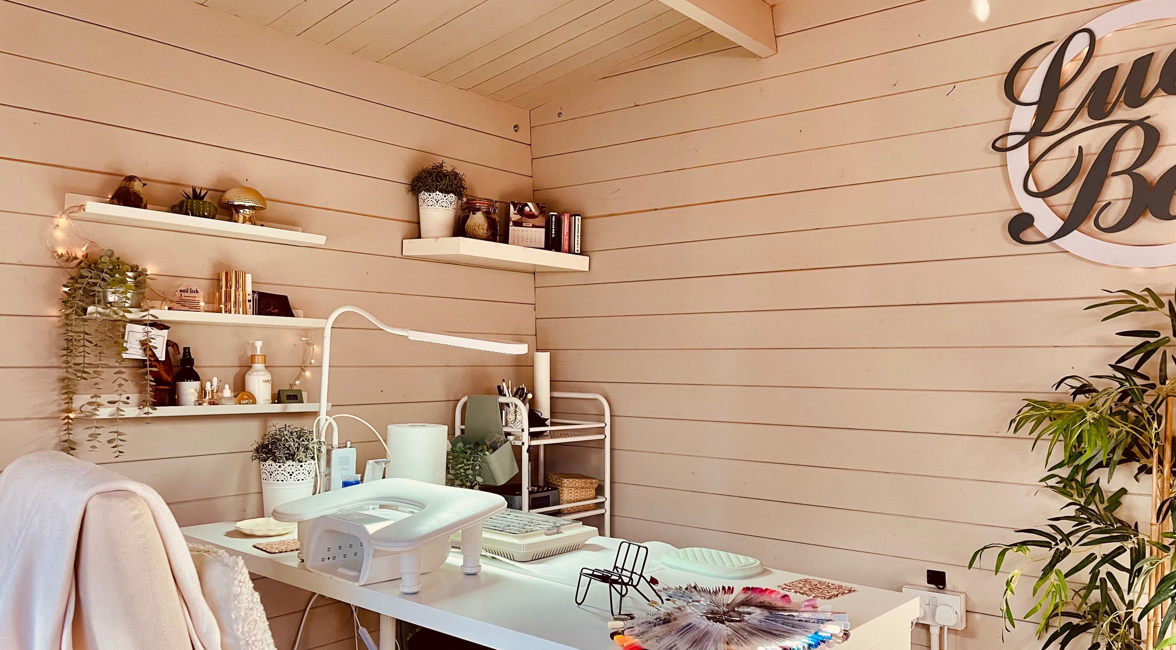 Calming nail studio at Lucy Boo in Kinross, Scotland, GB, featuring tidy shelves and cozy decor.