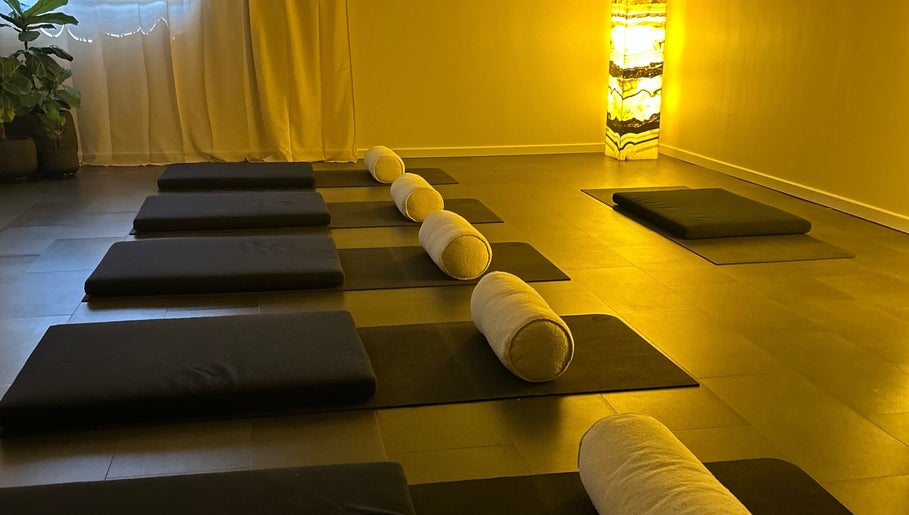 Peaceful yoga studio at Henosis & Co, Perth, Western Australia, AU with warm lighting and mats.