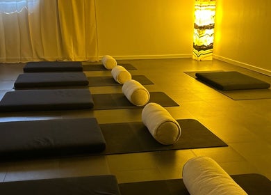 Peaceful yoga studio at Henosis & Co, Perth, Western Australia, AU with warm lighting and mats.