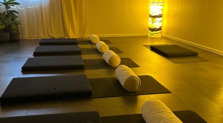 Peaceful yoga studio at Henosis & Co, Perth, Western Australia, AU with warm lighting and mats.