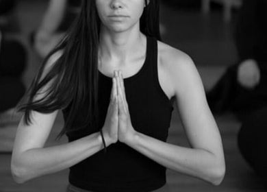 Person meditating in yoga class at Henosis & Co, Perth, Western Australia, AU.