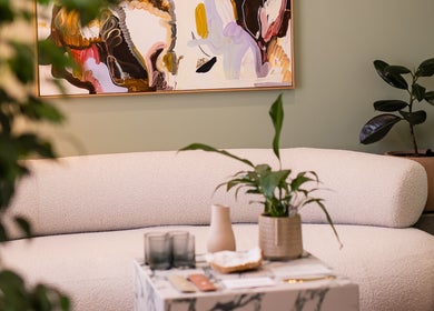 Modern lounge at Henosis & Co with abstract art, plush sofa, and plants in Perth, Western Australia, AU.