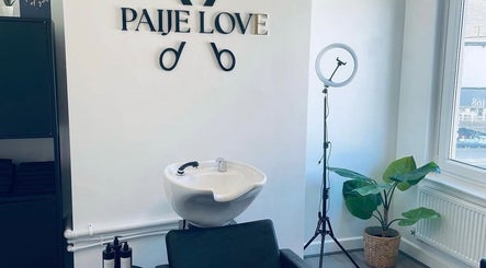 Interior of Paije Love Hair in Rainhill, England, showcasing a stylish wash basin and modern decor.