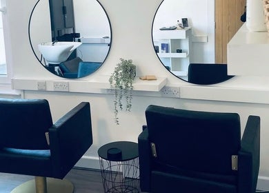 Chic salon interior at Paije Love Hair, Rainhill, England, GB, featuring elegant chairs and mirrors.
