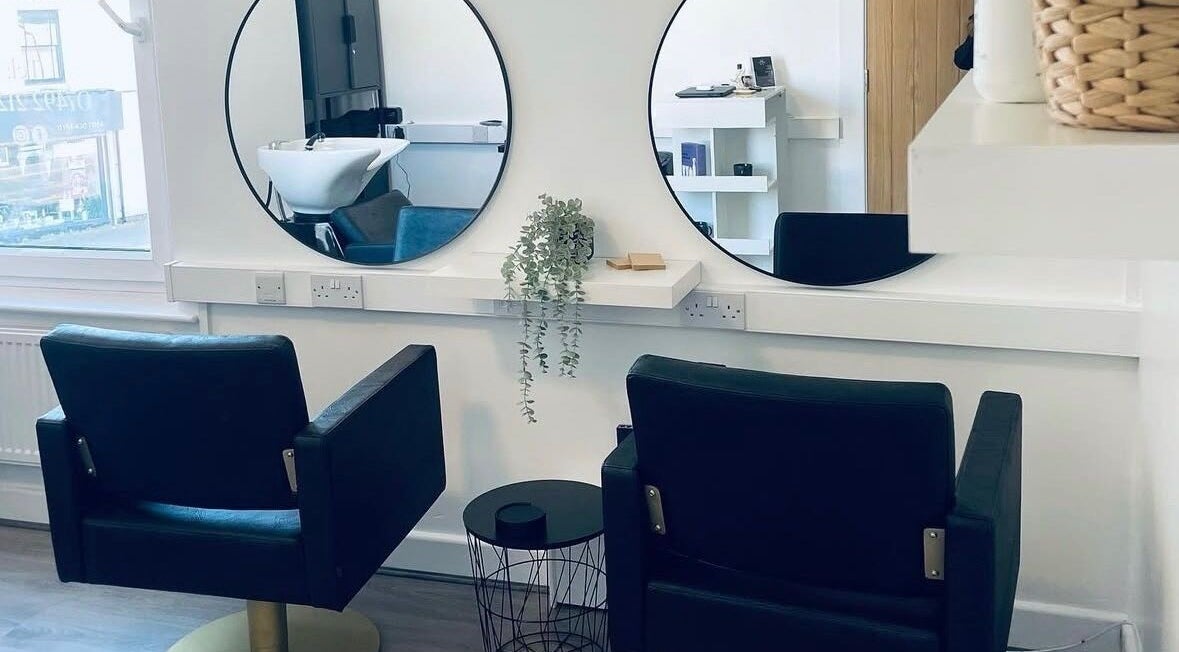 Chic salon interior at Paije Love Hair, Rainhill, England, GB, featuring elegant chairs and mirrors.