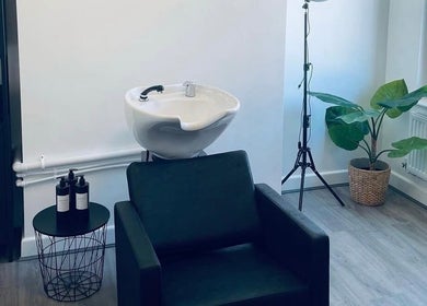 Modern wash station at Paije Love Hair, Rainhill, England, GB with stylish seating and decor.