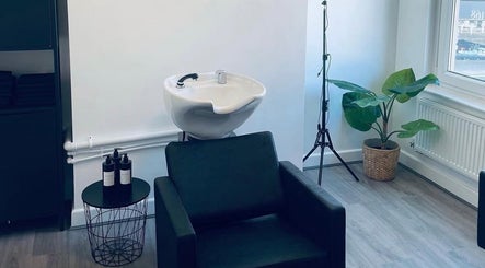 Modern wash station at Paije Love Hair, Rainhill, England, GB with stylish seating and decor.