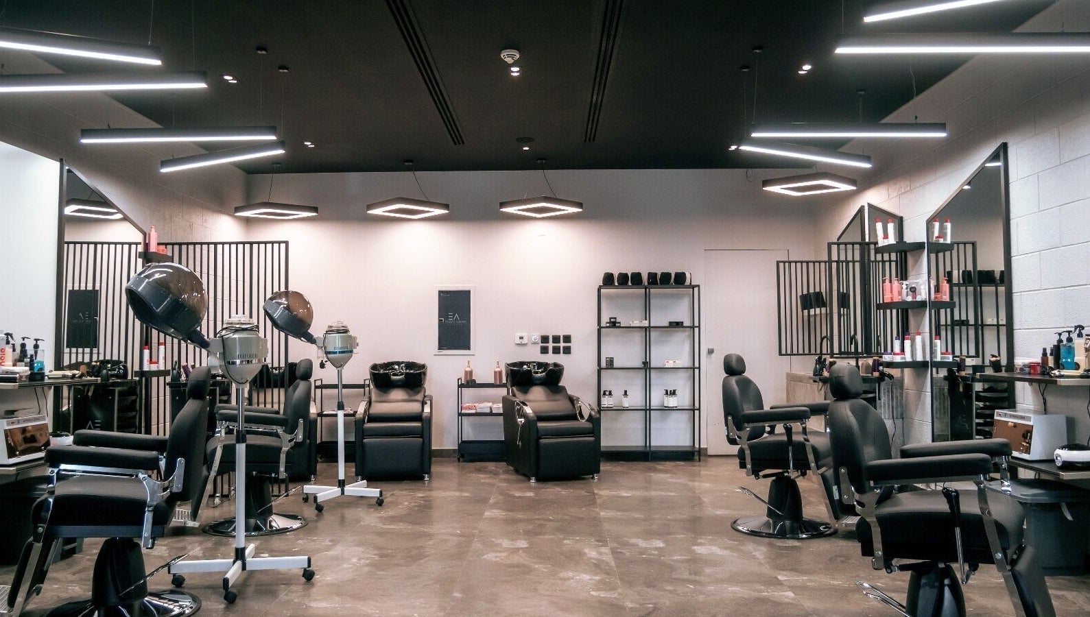 Modern salon setup at Elegance Address EA in Riyadh, Riyadh Province, SA, featuring stylish black chairs and equipment.