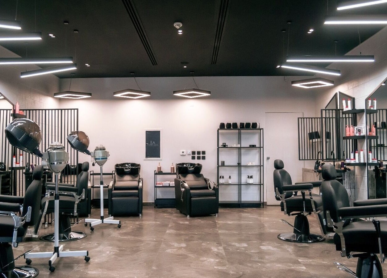 Modern salon setup at Elegance Address EA in Riyadh, Riyadh Province, SA, featuring stylish black chairs and equipment.