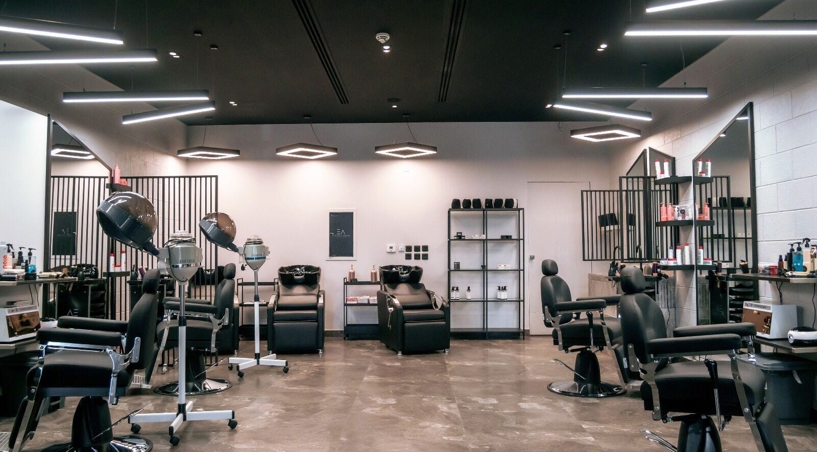 Modern salon setup at Elegance Address EA in Riyadh, Riyadh Province, SA, featuring stylish black chairs and equipment.