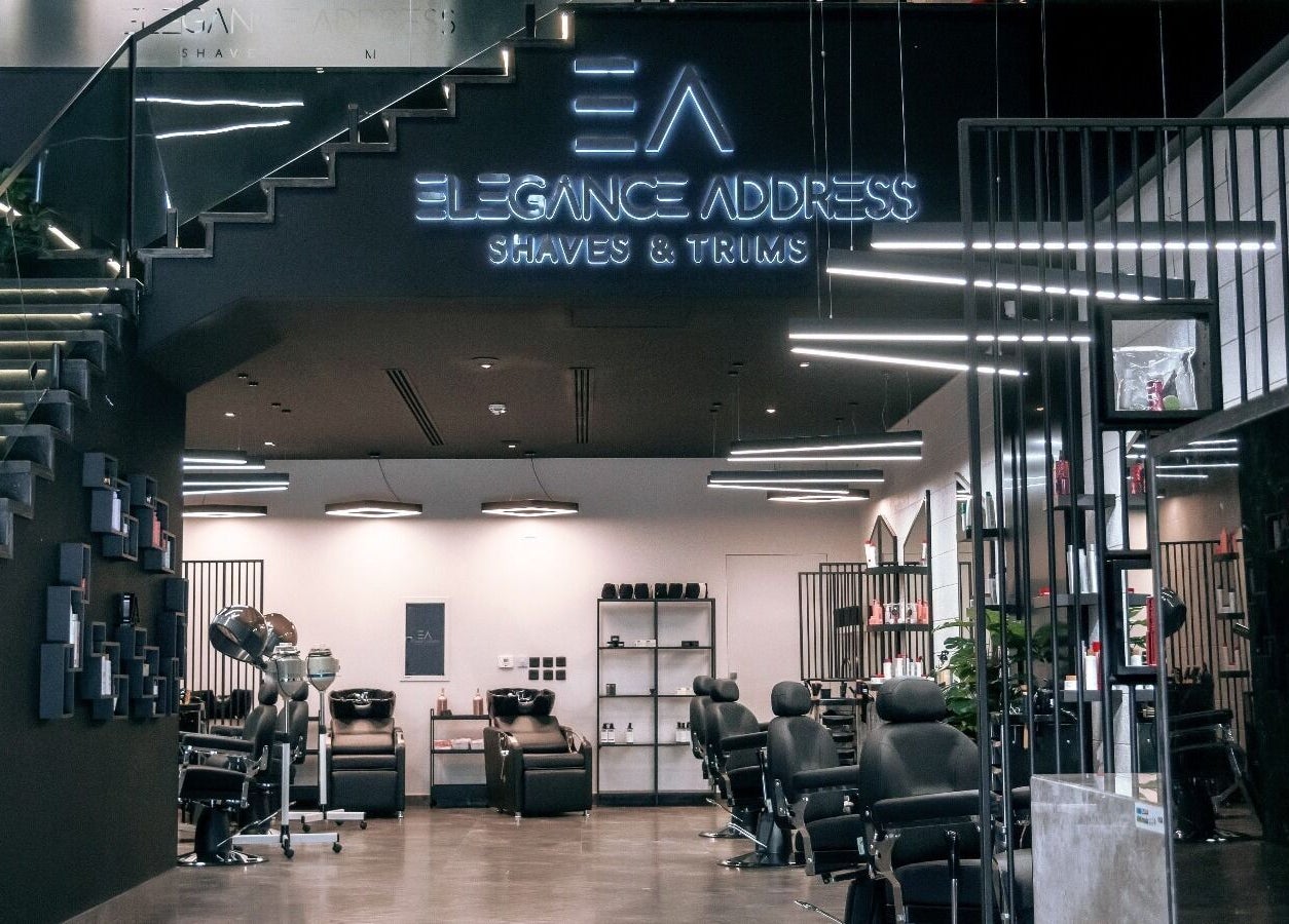 Sleek interior of Elegance Address EA in Riyadh showcasing modern barber chairs and stylish decor.