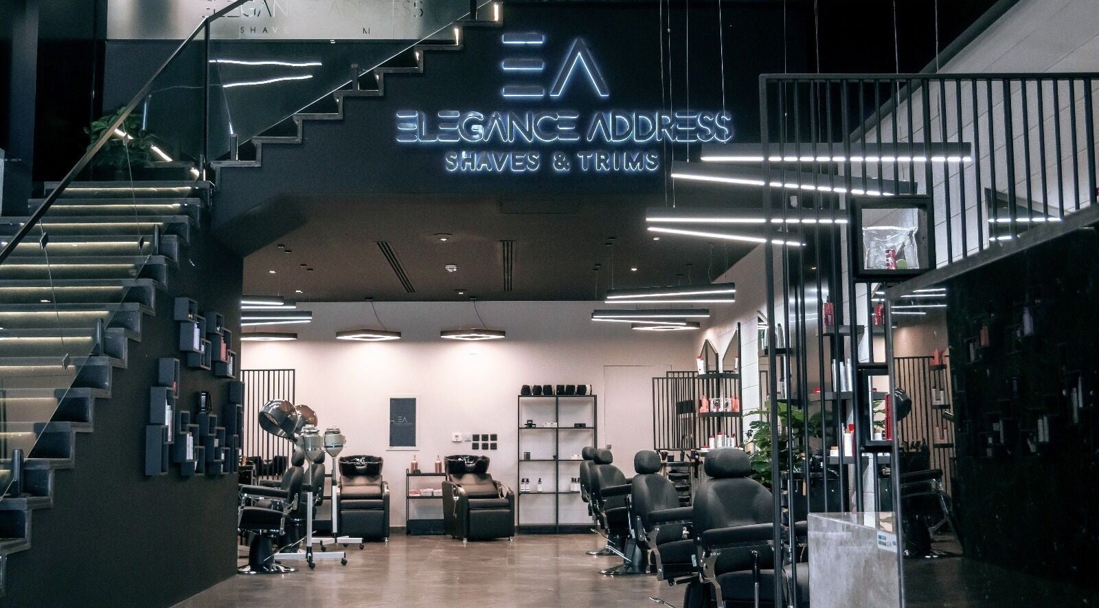 Sleek interior of Elegance Address EA in Riyadh showcasing modern barber chairs and stylish decor.
