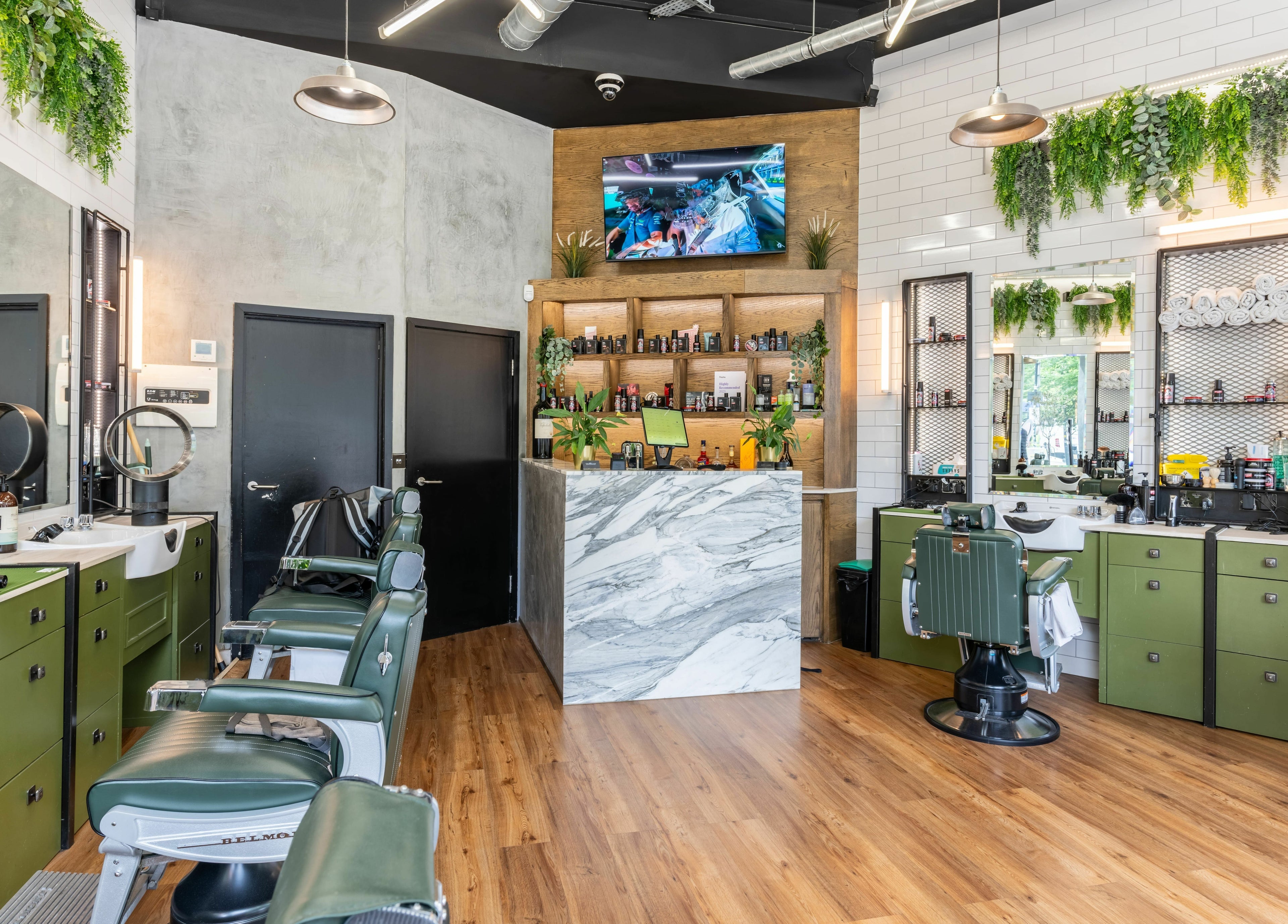 Stylish salon interior at The Axe Club in Camden, London, England, GB with modern decor and barber chairs.