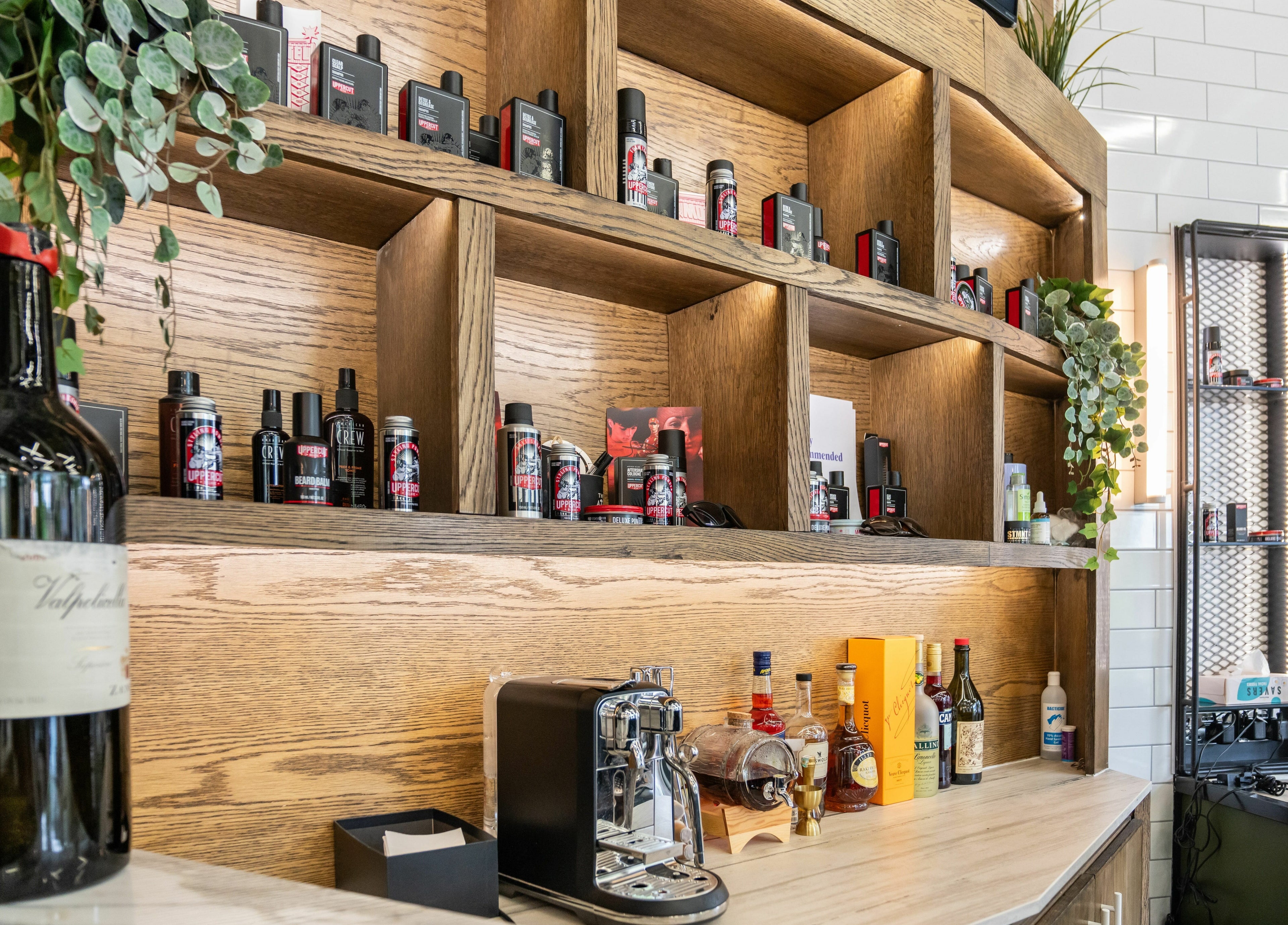 Stylish wooden shelves with products at The Axe Club in Camden, London, England, GB. Cozy, elegant atmosphere.