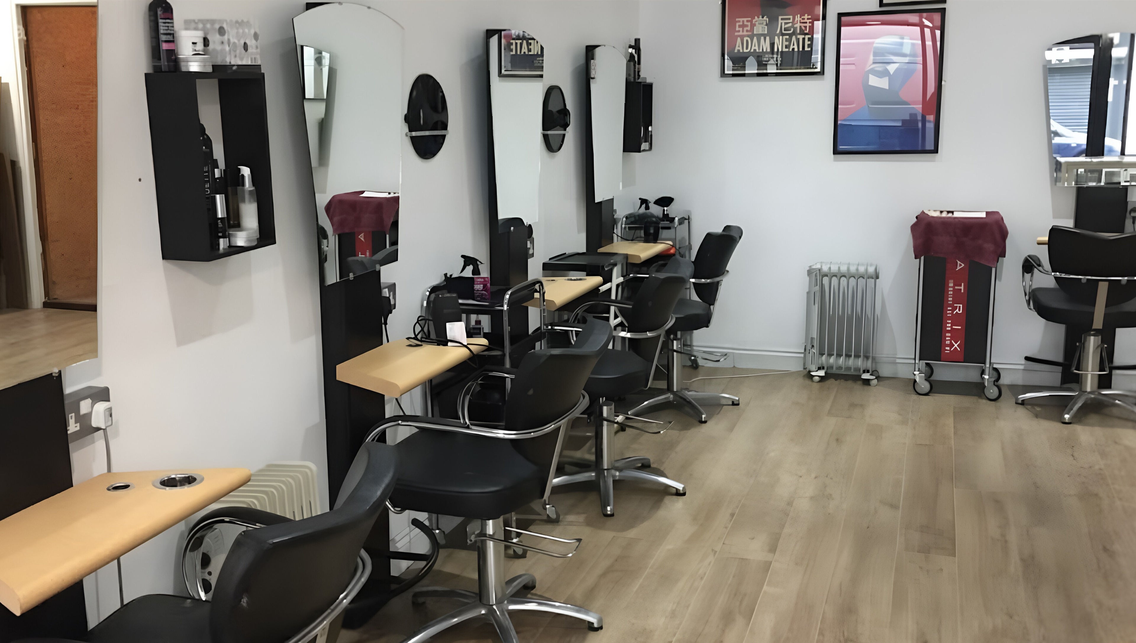 Interior of Nelly McNally salon in Southend-on-Sea, England, GB, featuring modern styling chairs and mirrors.