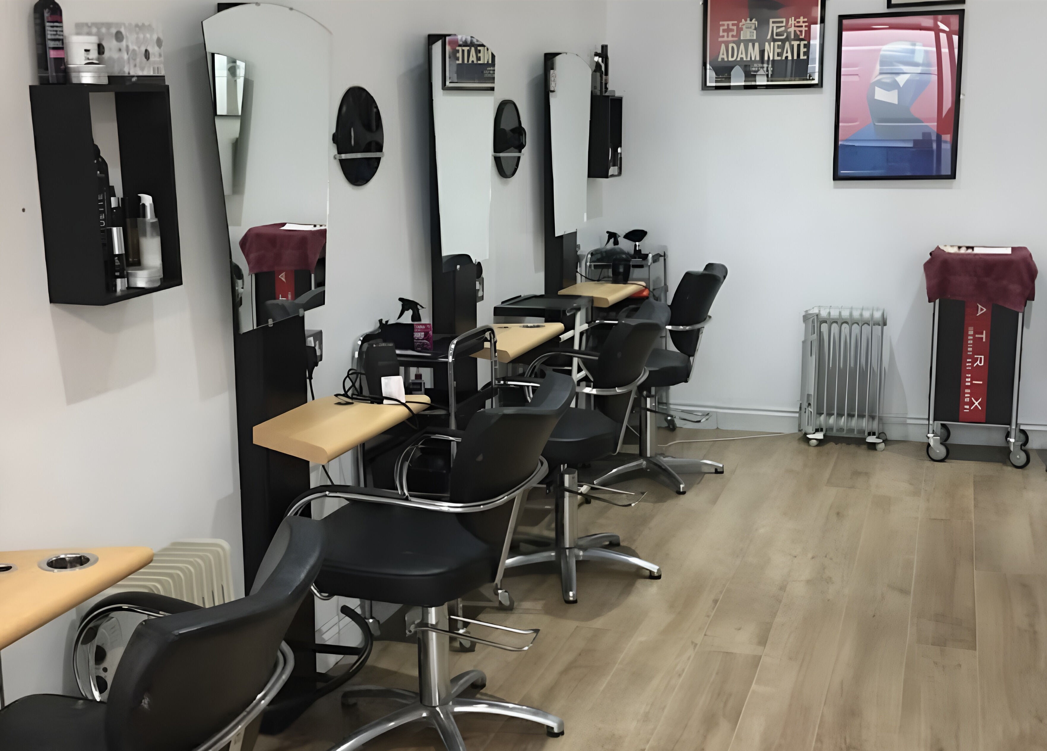 Interior of Nelly McNally salon in Southend-on-Sea, England, GB, featuring modern styling chairs and mirrors.