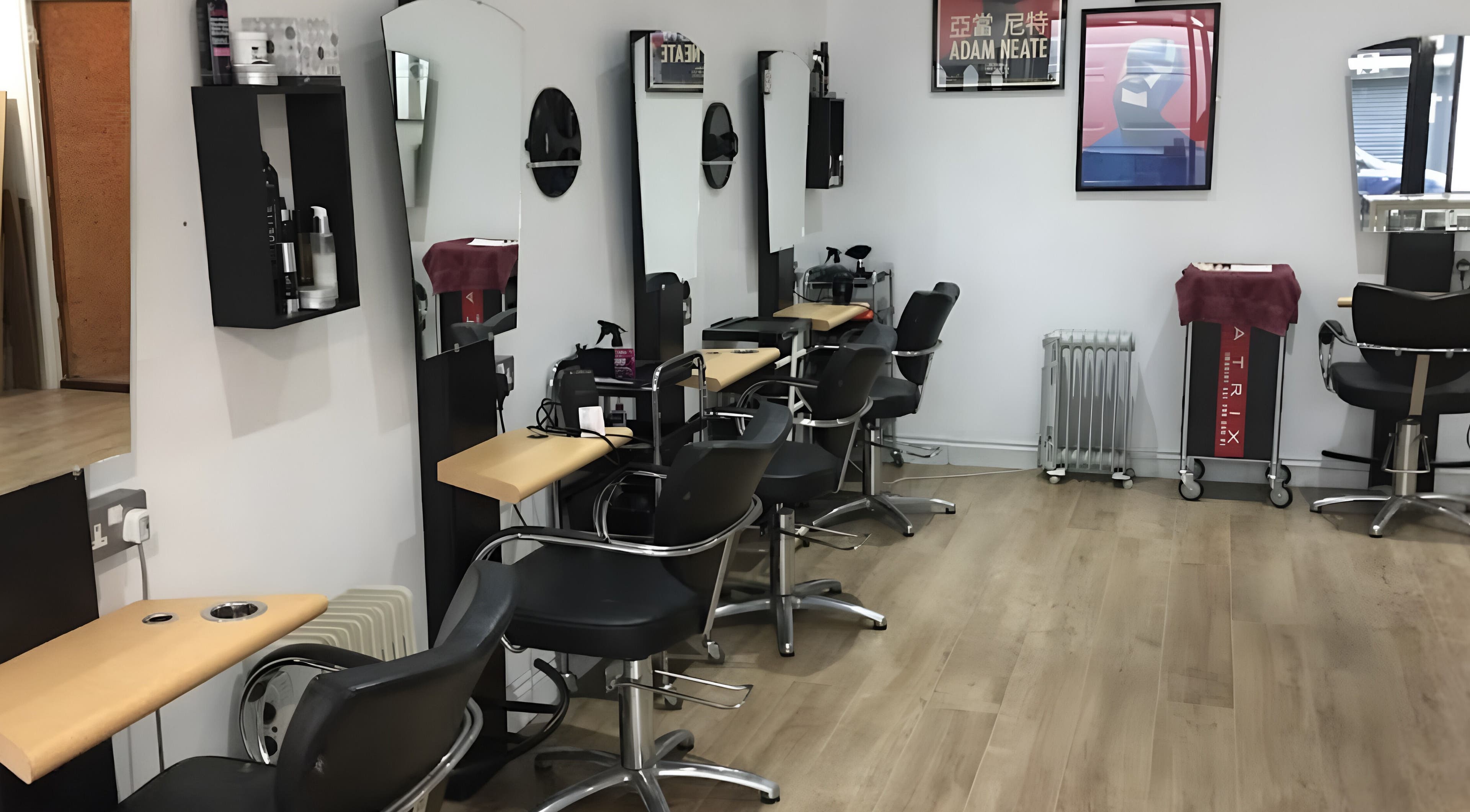 Interior of Nelly McNally salon in Southend-on-Sea, England, GB, featuring modern styling chairs and mirrors.
